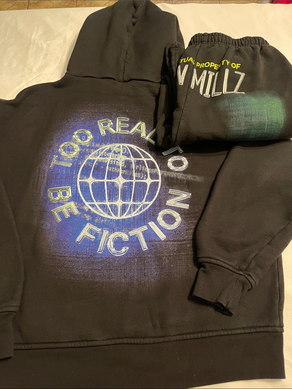 Black Graphic Hoodie with Blue 'Too Real To Be Fiction' Globe Print